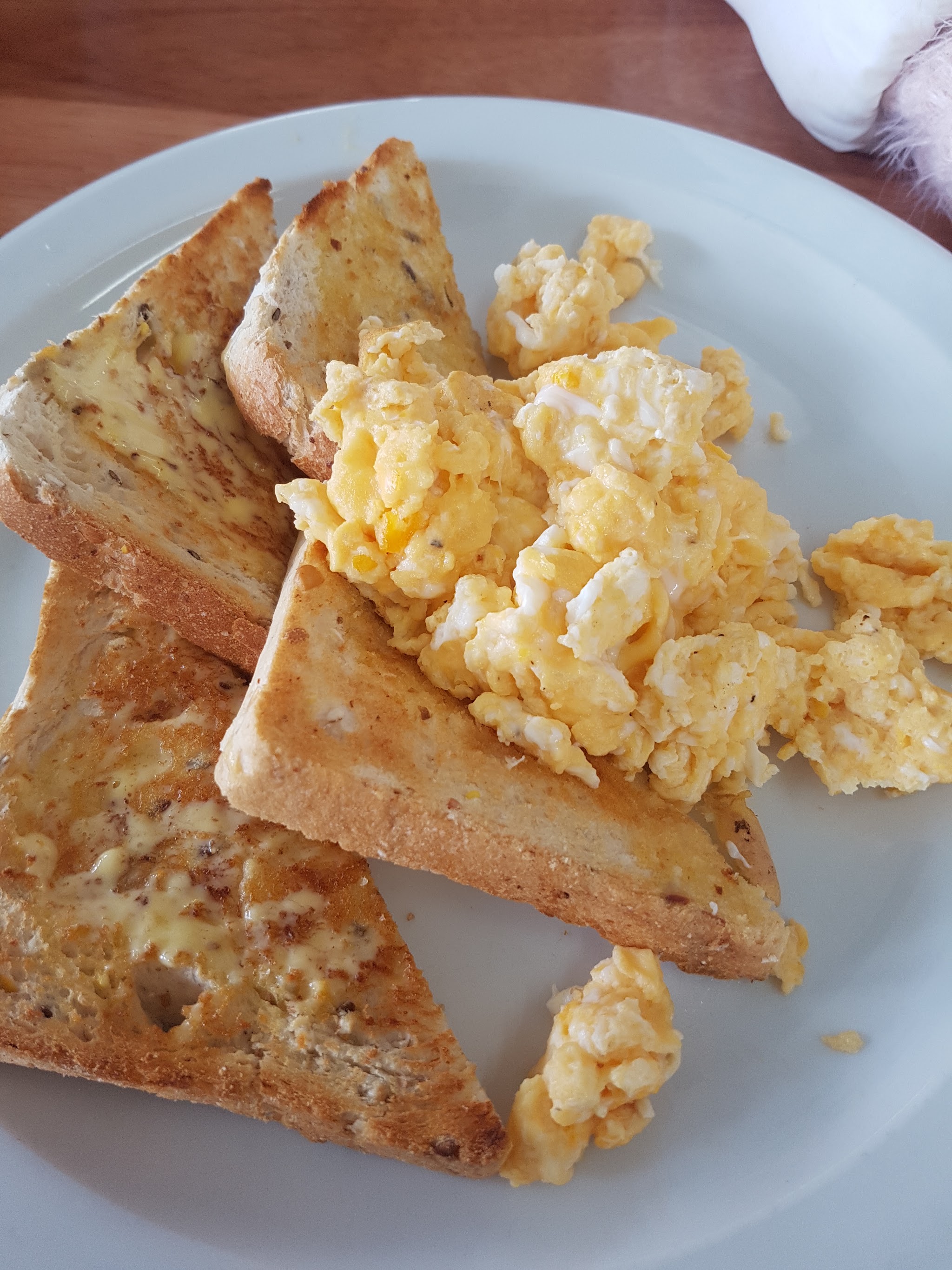 Scrambled eggs on buttered toast