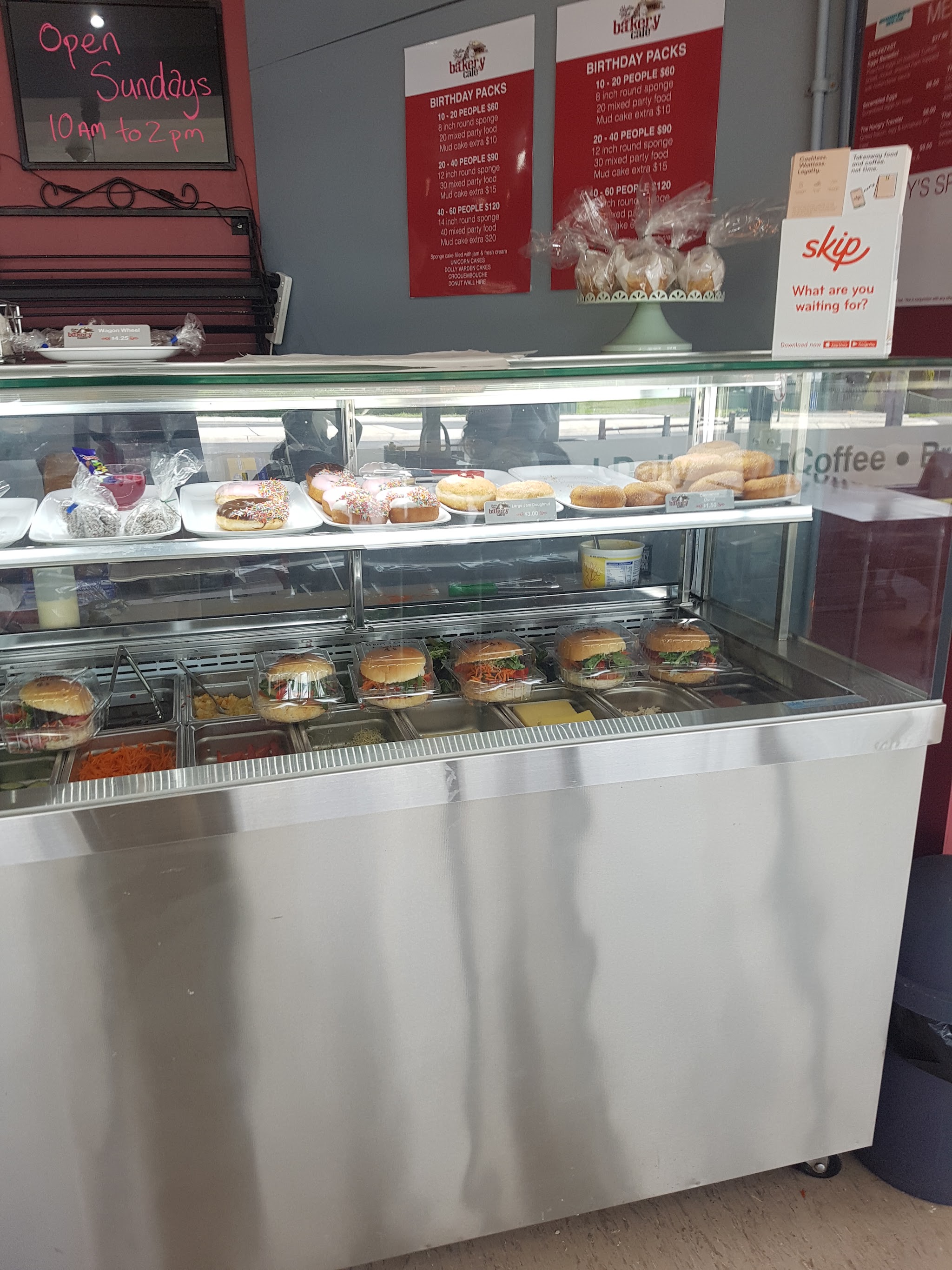 Bakery display cabinet with doughnuts, sandwiches and treats